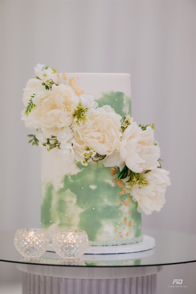 A green and floral themed wedding cake