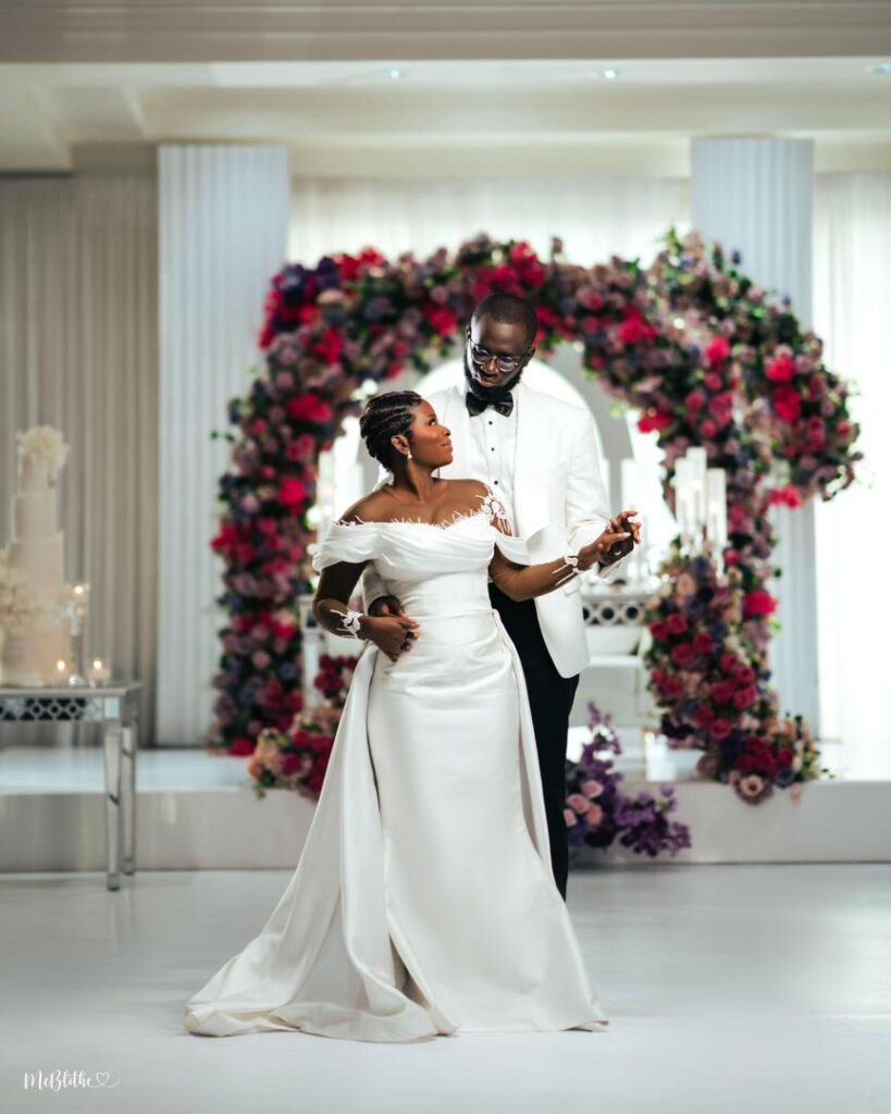 A couple in their white wedding outfit